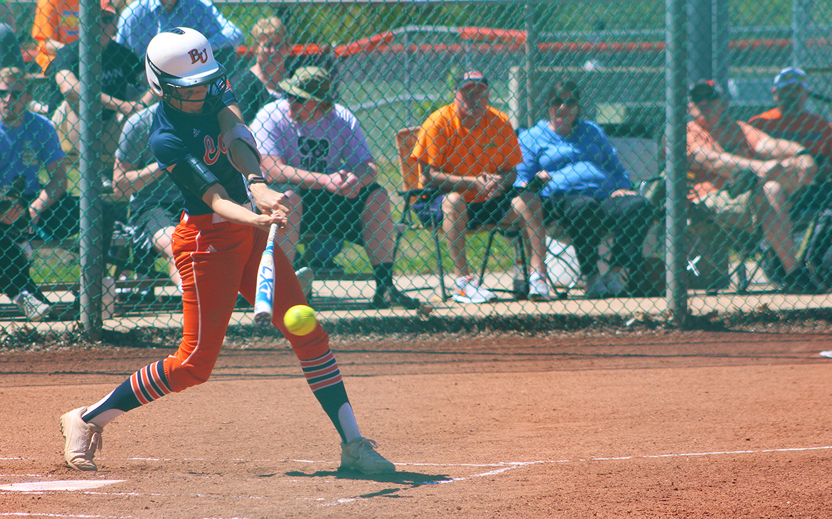 Sophomore Caitlin Hardgrove makes contact with a pitch during her time at bat. Image by Justin Toumberlin.