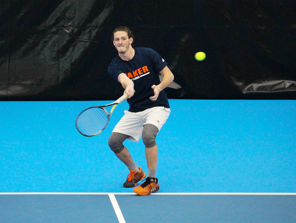 Senior+Austin+Keberlein+steps+into+a+forehand+in+his+singles+match+against+McPherson+College+on+Feb.+25.+Photo+by+Alex+Fortuna.