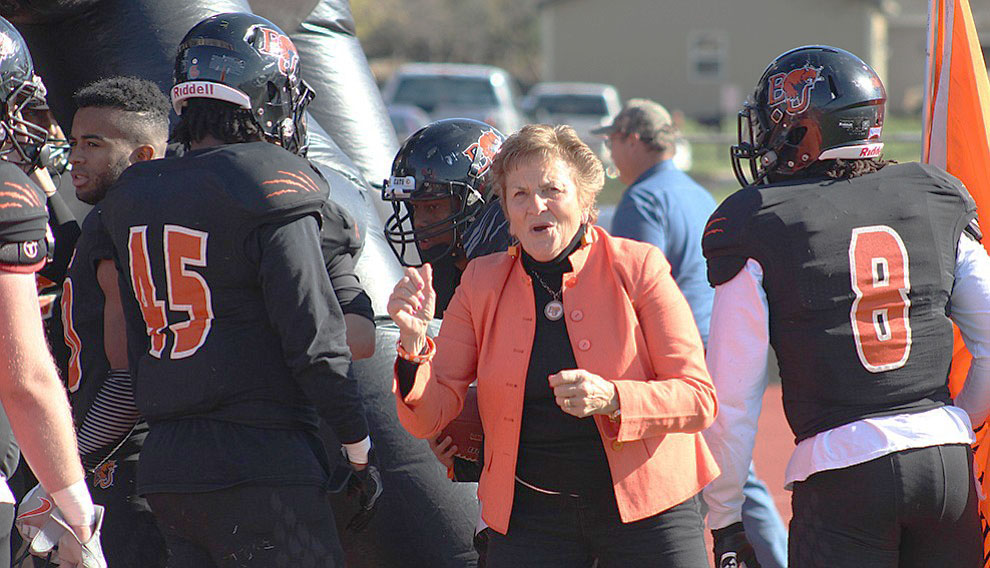 Former director of the Student Health Center Ruth Sarna peps up the BU football players before they take the field against Evangel on Nov. 12 at Liston Stadium. Sarna is one of the Baker sports teams most enthusiastic supporters. Image by Shelby Stephens.