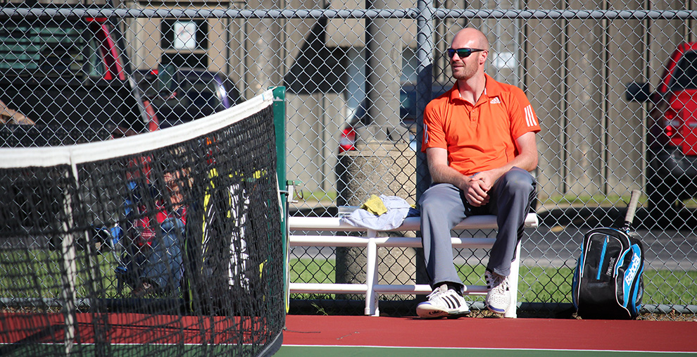 Head+tennis+coach+Keith+Pipkin+watches+a+match+Oct.+7+against+William+Jewell+College.+Pipkin+is+in+his+first+year+at+Baker.+Image+by+Jenna+Black.