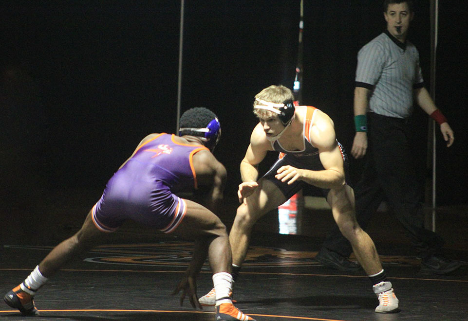 Defending national champion Victor Hughes studies his opponent during a home dual against Missouri Valley Jan. 16. Hughes won by a 1-0 decision. Image by Shelby Stephens.
