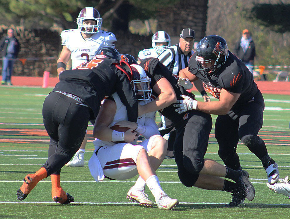 The Baker defense makes one of its five sacks on Evangel quarterback Blake Woodard on Nov. 12 at Liston Stadium. The win gave Baker its first 11-0 start to the season in school history. Image by Shelby Stephens.