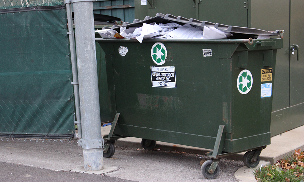 A small recycling bin outside the Harter Union overflows with paper. Image by Elizabeth Hanson.