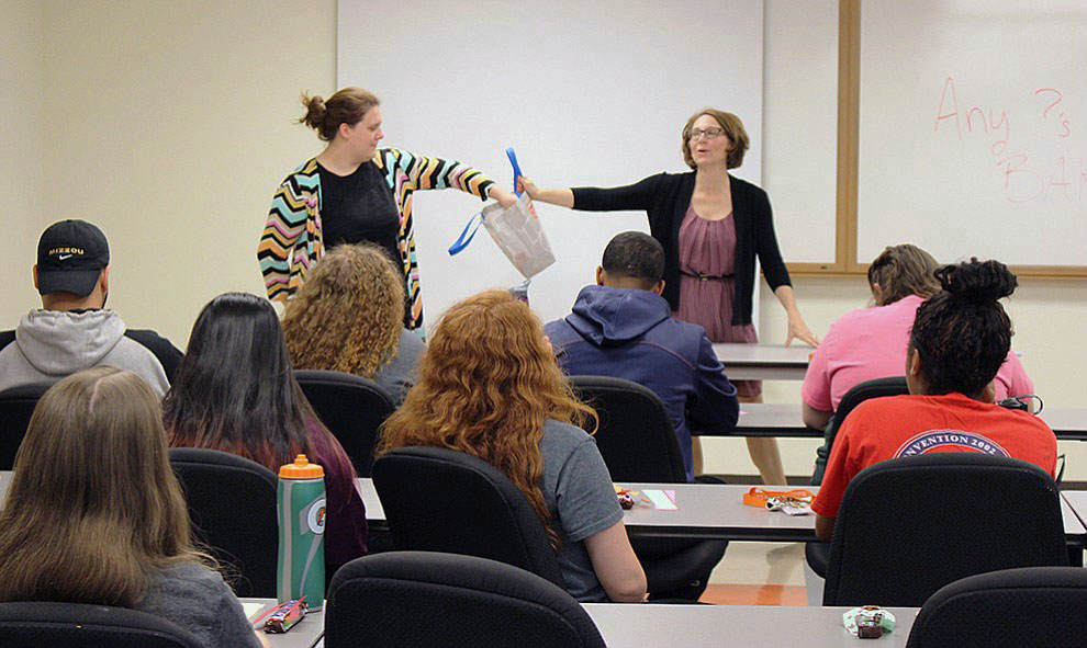 Junior Madison Brown and Dean of Students Cassy Bailey draw questions from a bag written by freshmen in a Salon 101 class. Image by Elizabeth Hanson.