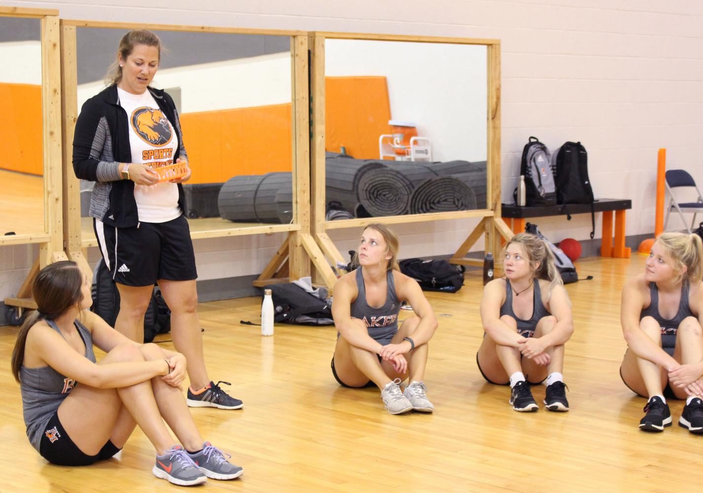 Head dance coach Lynsey Payne instructs dancers during a preseason practice inside Mabee Gym August 14.