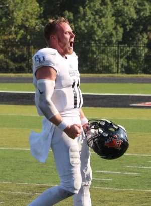 Senior quarterback Logan Brettel yells in celebration of the Wildcats win over Benedictine. Brettel threw a total of 362 yards from 21 completed passes. 