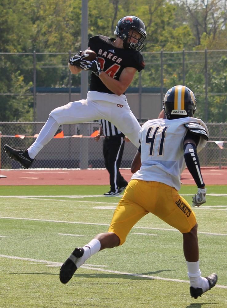 Wide receiver, freshman Nick Snider, leaps to catch senior Logan Brettels 33 yard pass during the second quarter. 
