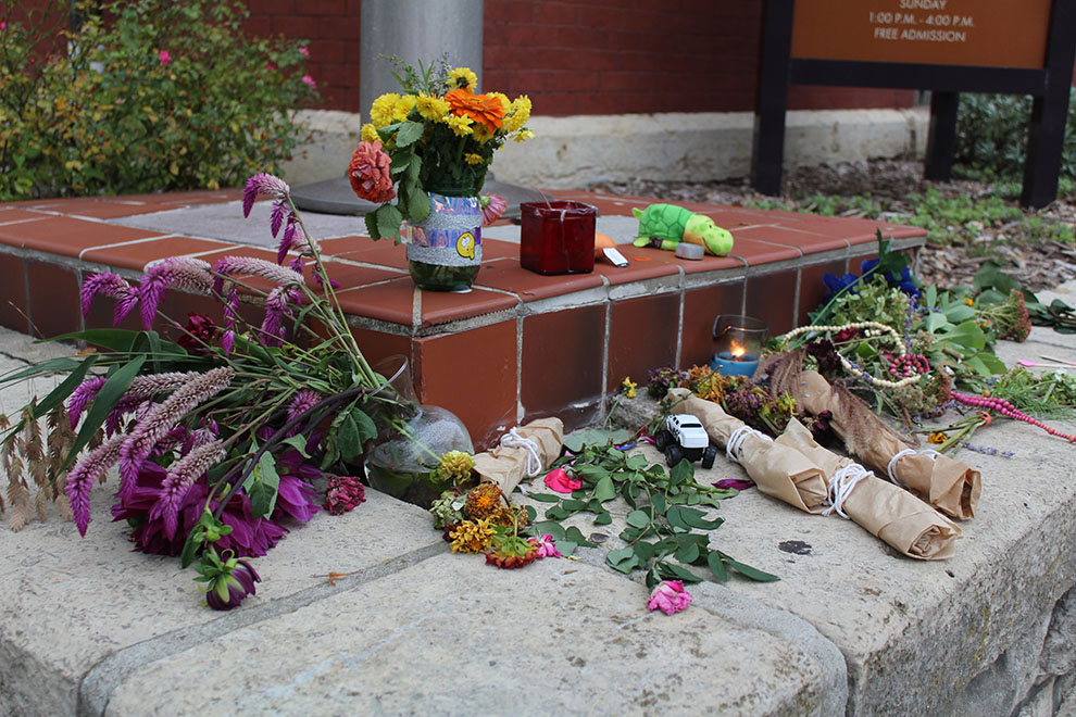 A small memorial is assembled at the corner of 11th and Massachusetts street in honor of three people who lost their lives Oct. 1. Items gathered at the memorial included flowers, candles and more.