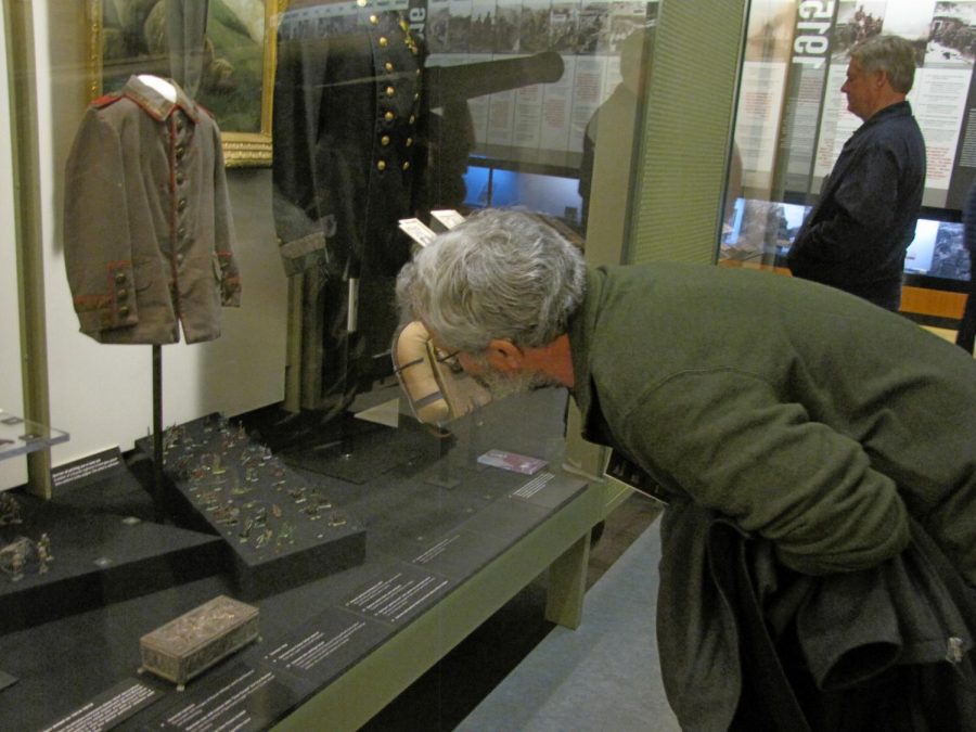 John Richards, professor of history, bends down to examine weaponry used in the first World War. Richards, along with History Club, visited the National World War I Museum in downtown Kansas City on Nov. 12 in honor of Veterans Day. The museum features several artifacts including artillery, uniforms, medical tools and a tank, all used during the war.