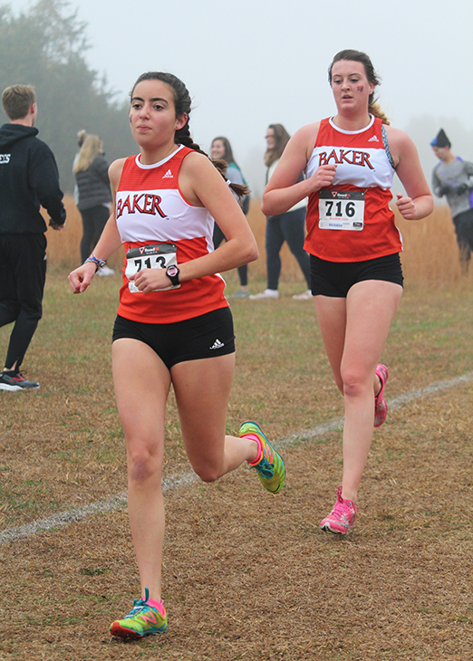 Seniors Caitlin Apollo and Rachel Campbell run in their final cross country race. The womens team finished fifth in the conference race.