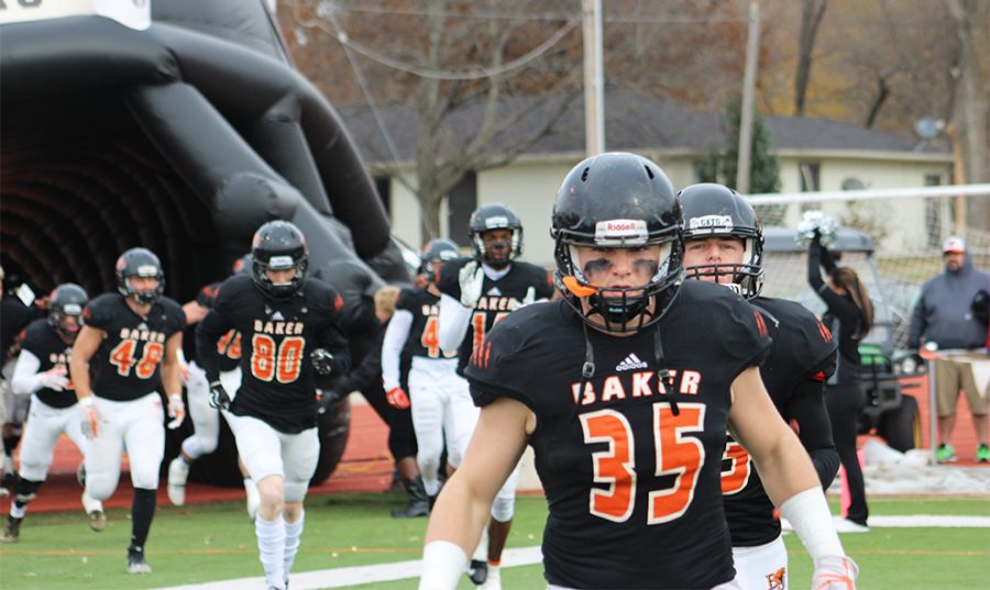 Freshman Justin Howard and teammates run out of the inflatable football helmet prior to the first round of the NAIA playoff games.  President Lynne Murray offered the first 100 students free admission through the gate. The Wildcats lost to Georgetown 36-33.