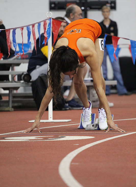 Junior Gloria Mares sets into her blocks right before the gun goes off for the womens 200 meter dash. Mares finished fourth with a 26.83. She set her personal record this season with a 26.23 at Bob Timmons Challenge earlier this winter. Mares is also a member of Bakers 4x4 relay team that competed at the Jayhawk Classic. 