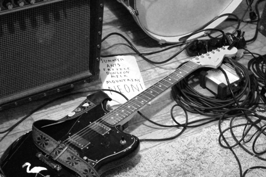 Tre Byers guitar next to the nights set list. Byers and his band Dodging played a 30 minute set at a house show in Lawrence on Feb. 3.