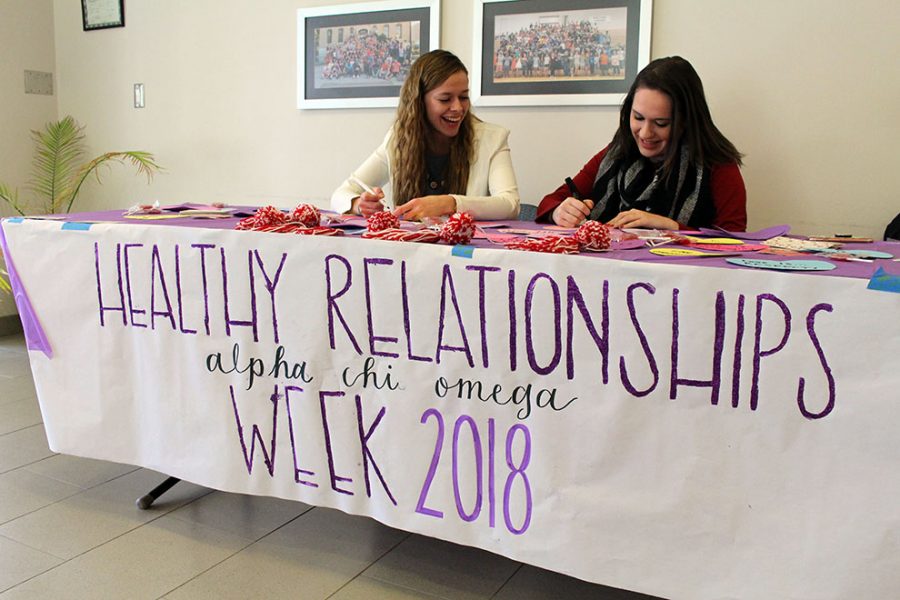 Alpha Chi Omega members Darby Fugitt and Alanna Dierking ask students what love means to them in Harter Union on Feb. 12. The sorority is celebrating Healthy Relationships in support of their philanthropy Domestic Violence Awareness.