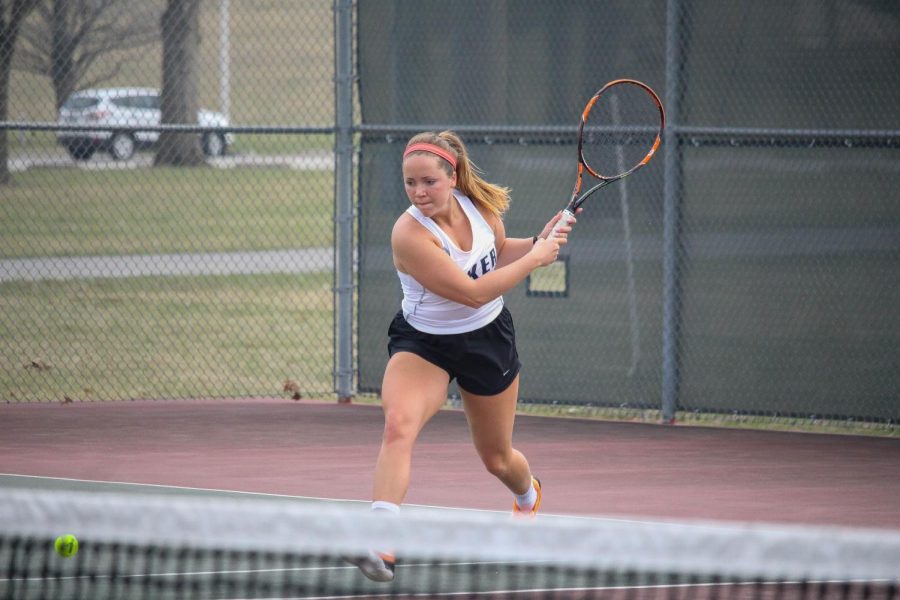 Senior Holly Chestnut lunges for a ball in her match at Ottawa University.