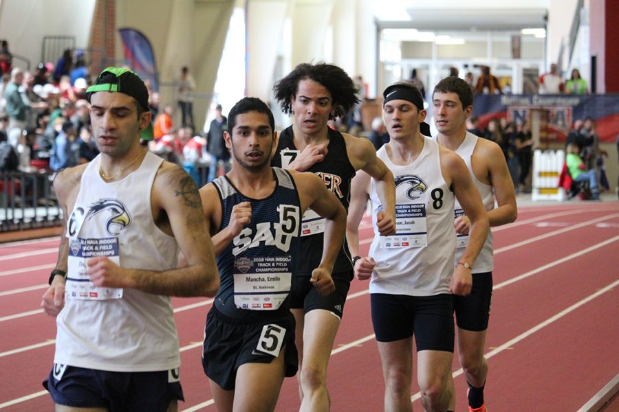 Junior Moses Watson attempts to close in on junior Emilio Mancha of St. Ambrose University at the 2018 NAIA Indoor Track & Field National meet. Watson is the 2019 indoor 3-kilometer race walk national champion.