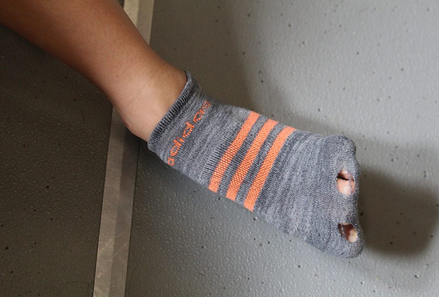 McCulloms hole-clad lucky sock that she wears every time she races. The senior racewalker likes to wear Bakers signature orange on her socks and in her hair with an orange hair band.  