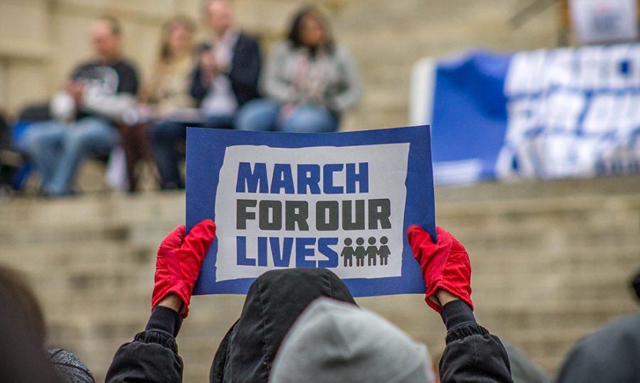 A protester holds their sign aloft in support of the March of Our Lives event on March 24 in Topeka. The main march was held in Washington, D.C., but sister marches were held all over the country.