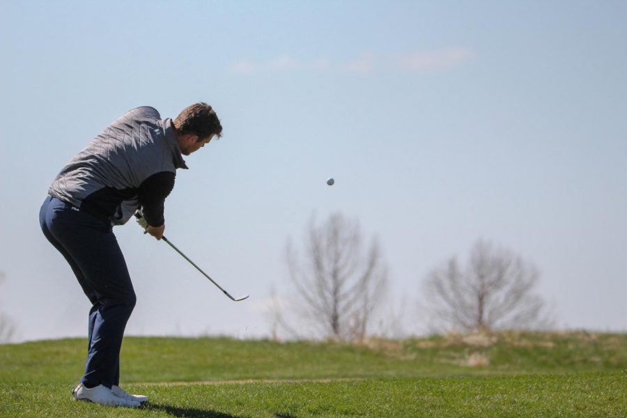 Senior Riley Kemmer watches closely as he finishes a chip shot during the Baker Spring Invitational at Eagle Bend Golf Course on April 19. Kemmer tied for second place with rounds of 76, 75 and 72, just one stroke above the tournament champion. 