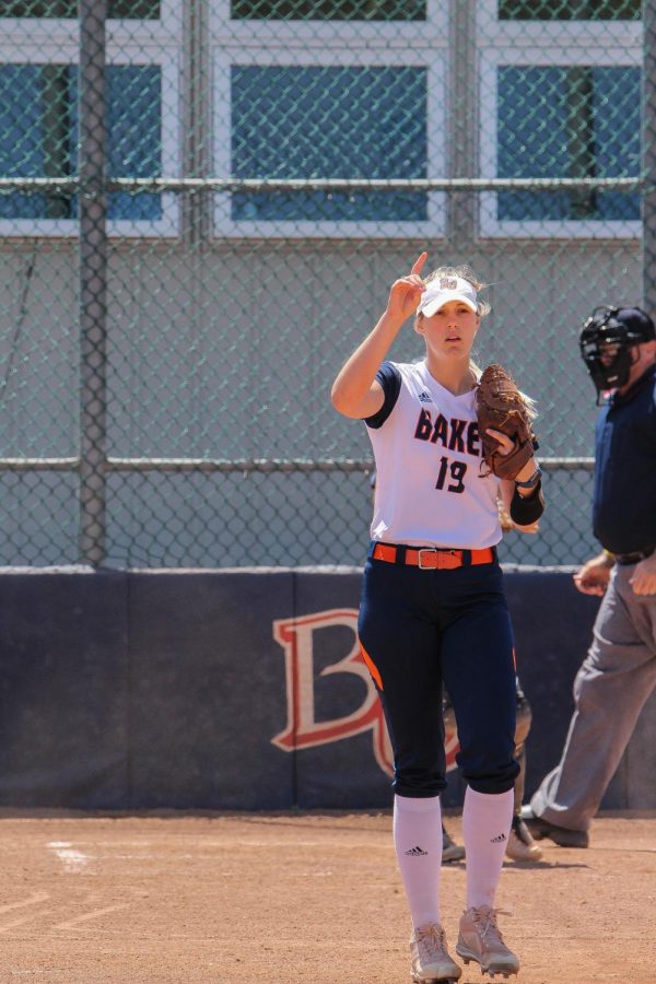 Starting pitcher, Olivia Brees signals one out to the rest of her defense against Clarke University.