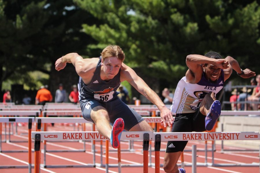 Senior Michael Riddle extends his leg over a hurdle in the 110 meter hurdles at the Heart meet. Riddle claimed seventh place in the 110 meter hurdles and and fourth in the 400 meter hurdles later the same day.
