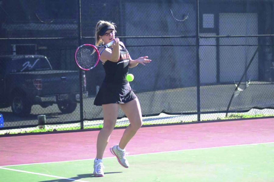 Freshman Janie King hits a forehand back to her Missouri Valley opponent in Baker’s last home match of the season. The team fell to MVC 7-2. 