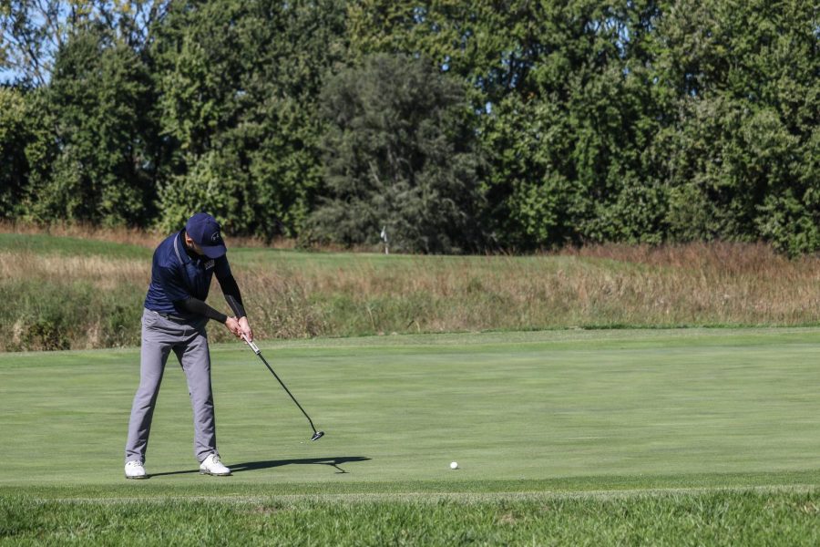 Cole Briggs hits a putt for birdie on the 3rd hole. Briggs recorded an 80 during round one of the Baker Invitational at Eagle Bend golf course in Lawrence.