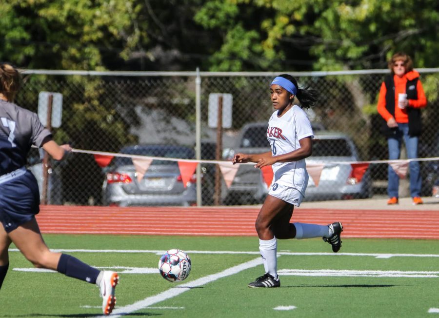 Maya Hodison, a midfielder for the Wildcats, looks for an open teammate as she dribbles the ball down the field. Hodison is a freshman from Lawrence, KS