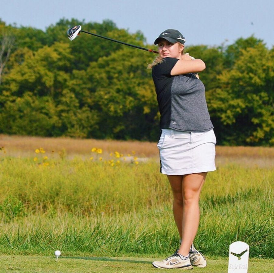 Senior Samantha Mitchell executes a practice swing before teeing off. Mitchell broke the womens golf school record for the lowest round, one below par.