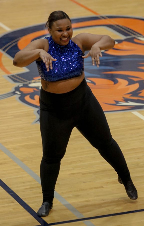 Sophomore Cheleia Marshall dances during the half time of the mens basketball team.