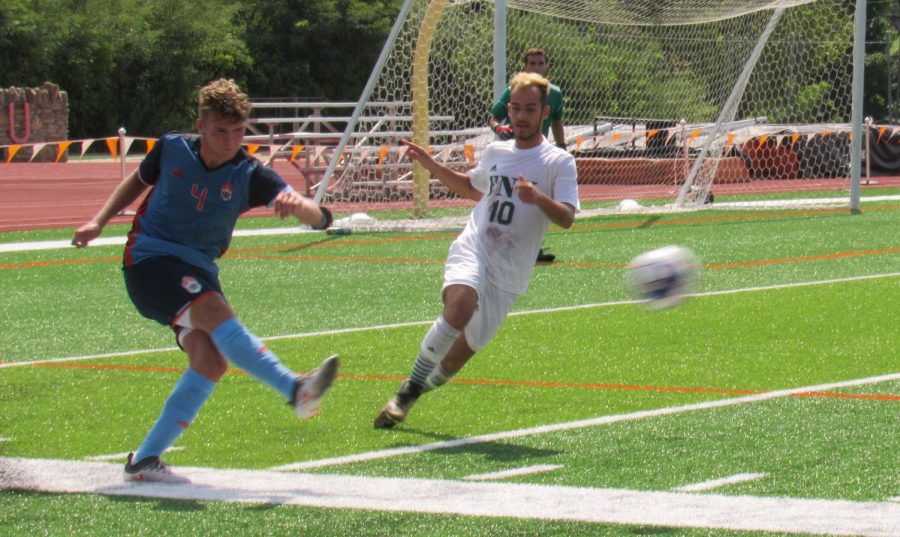 Florida National University forward presses freshman Massimo Salvoni as he clears the ball. Bakers current record for the 2019 season is 1-2-1.