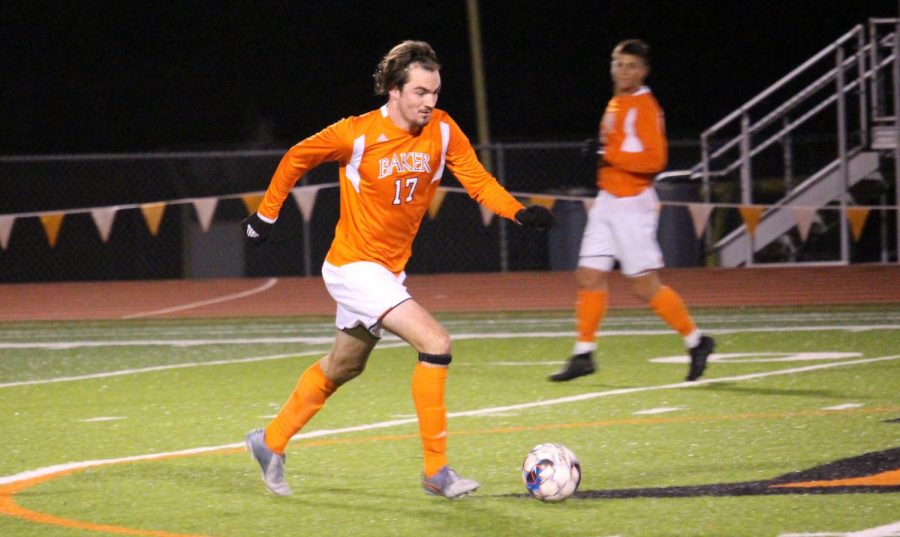 Senior Joah Hickel driving the ball through the center of the pitch. Center defender Hickel finishes his his final regular season with two goals and six shots on goal.