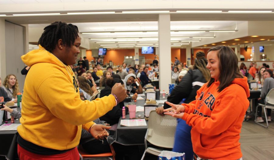 (Left) Freshmen Brandon Ammons and Brooklynn Lamberd play rock, paper, scissors to see who wins the round in grocery bingo. Student Activities Council holds grocery bingo Nov. 5 in the Harter Student Long Center.