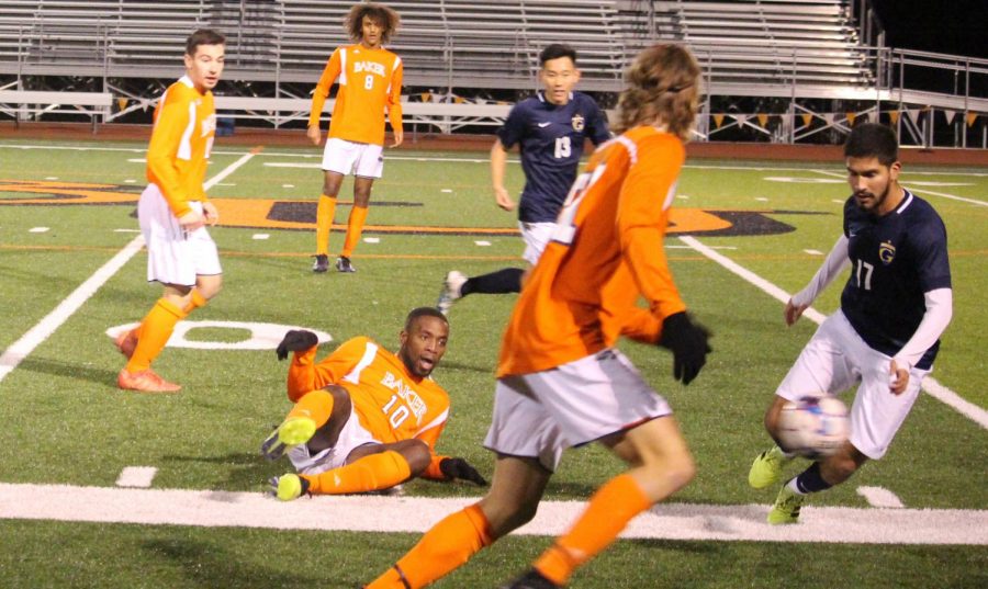 Senior Steve Pouna slides to pass up the line to sophomore Lucas Jacobs. Pouna joins the 2019-2020 senior class because of a redshirt in the prior season. Lucas Jacobs scores both goals on the night for the 2-0 victory.