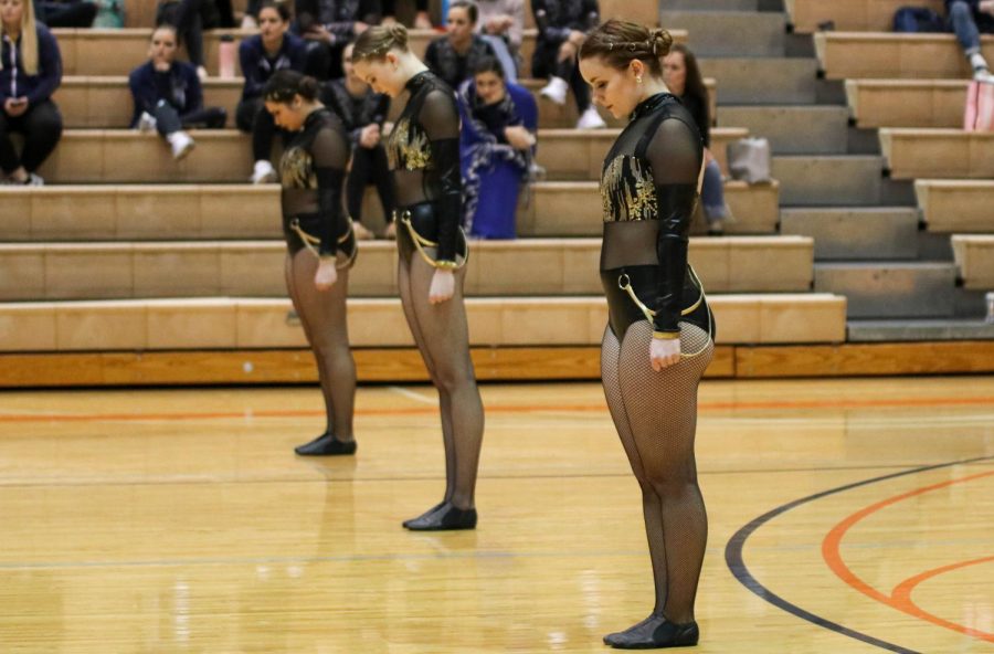 As the team gets ready to perform, Junior Paige Etheridge (right), Freshman Linnea Carlson (middle) and Freshman Taylor McEachron (left) take their places in anticipation for the music to begin. 