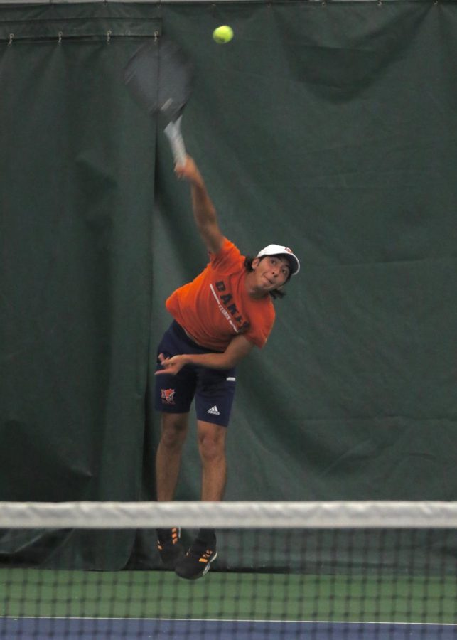 Sophomore Alejandro Hernandez serves during his singles match versus Cowley County Community College. Hernandez fell to his opponent 