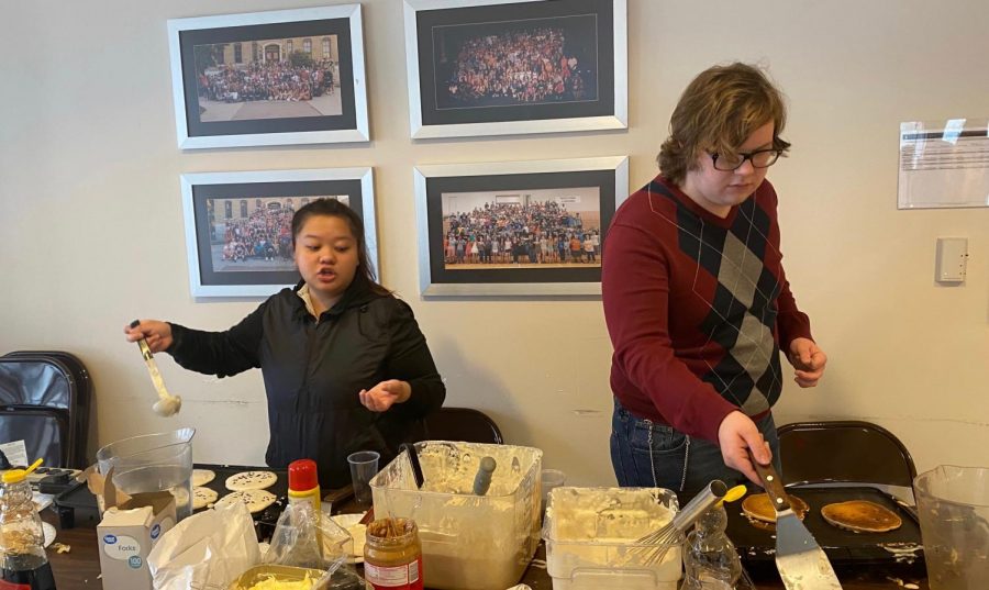 (Left) Senior Mindy Lo and sophomore Chance Prosser make pancakes for students in the Student Long Center. SAC promoted National pancake day Jan. 29 in the Long Student Center.