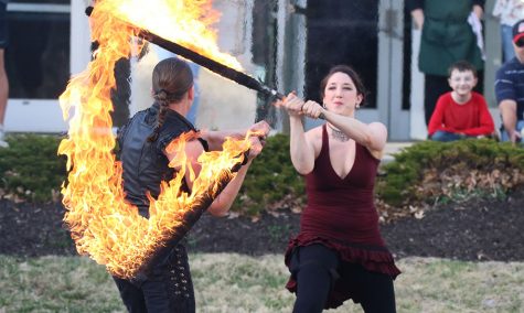 Cyricx and Viollca battle with flaming swords. They incorporated humor and wit throughout the performance to engage the audience on March 11.