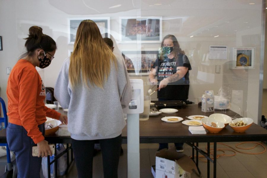 Students remained behind a plastic shield as they served their peers and faculty pancakes. 