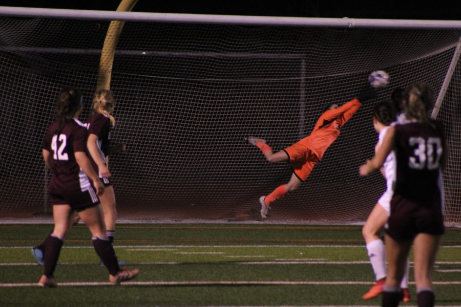 Baker makes a save as Evangel takes a shot at the goal.