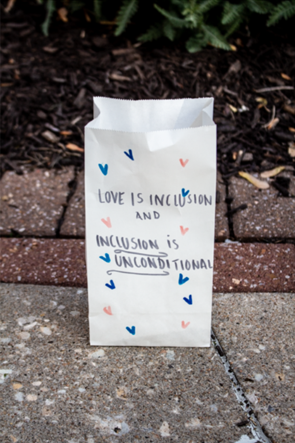 A paper bag sits behind the speakers to show support of “A Night  of Unity.”