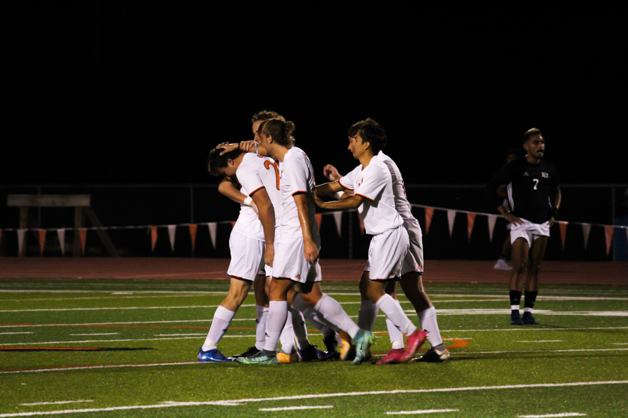 Junior Easton Weber is congratulated by teammates as he celebrates a goal bringing the score to 3-0 Baker.