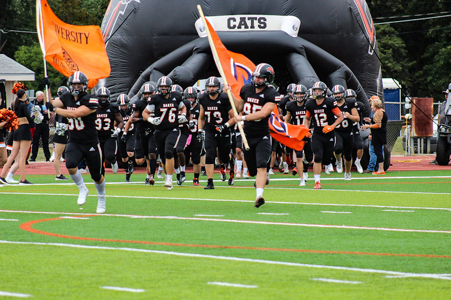 The Baker Wildcats enter the field for the start of the game against the Graceland Yellow Jackets on Oct 2.