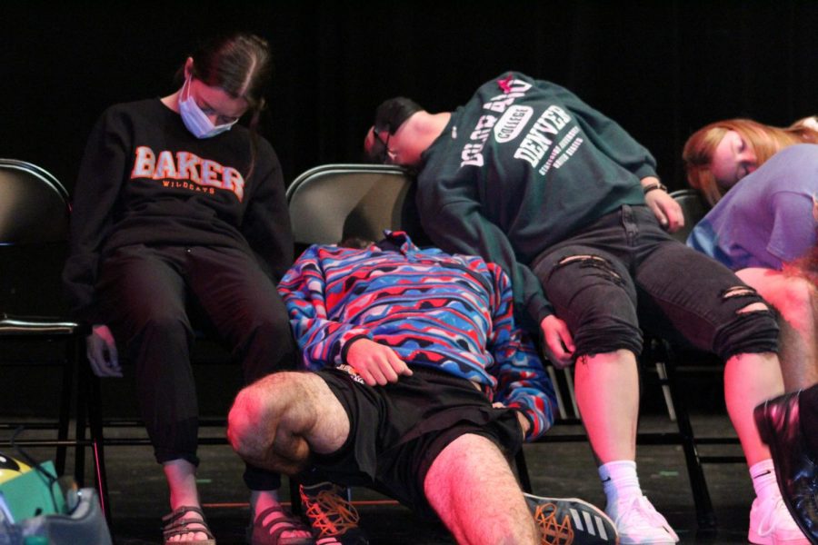 Junior Eric Pouch (center) slides out of his chair as the hypnotism continues.