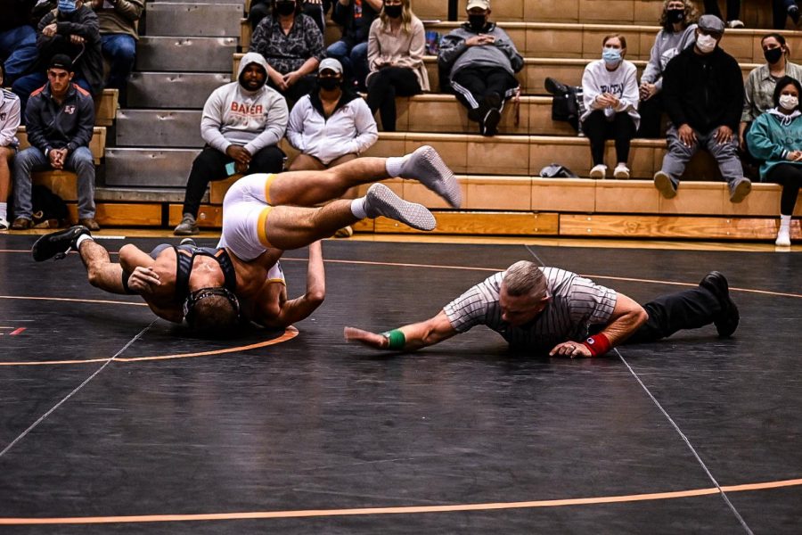 Sophomore Joey Hancock pins his opponent early in the match.