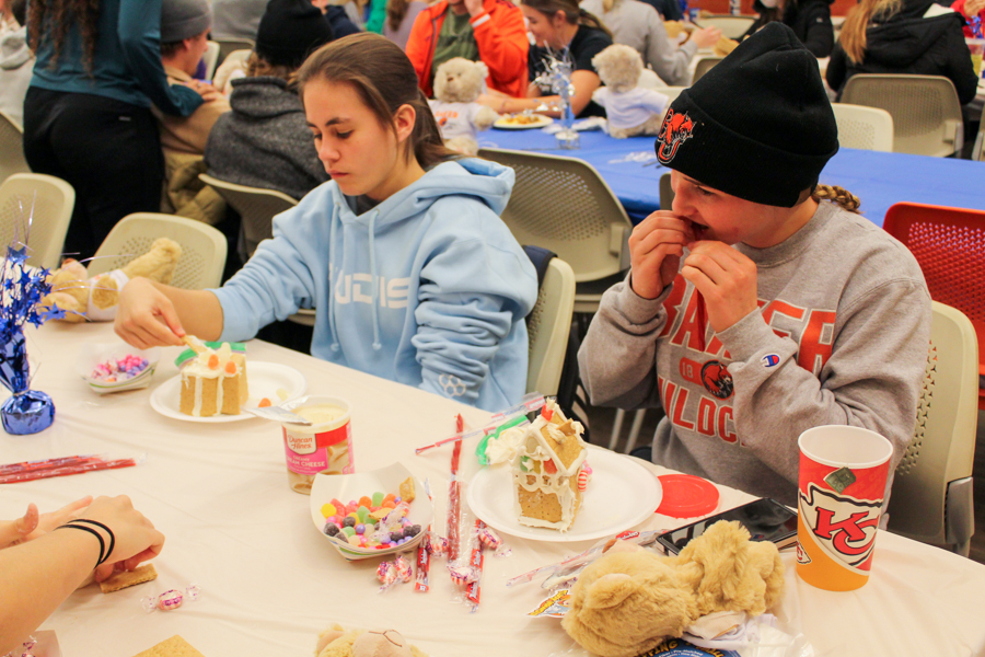 Freshman Kassidy Leiszler and Sophomore Nichole Moore work hard to construct their gingerbread houses.