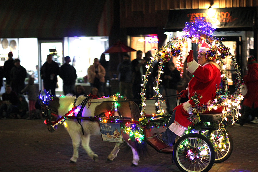 A Santa is pulled in a horse-drawn carriage for the Festival of Lights parade as a part of the Hometown Christmas festival on Dec. 4. 
