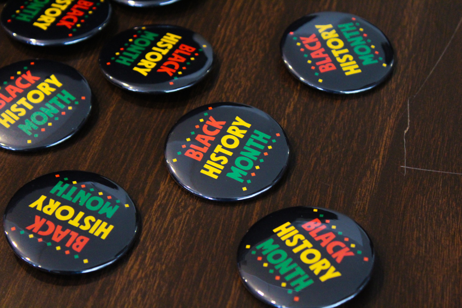 Black History Month buttons are passed out at the event.
