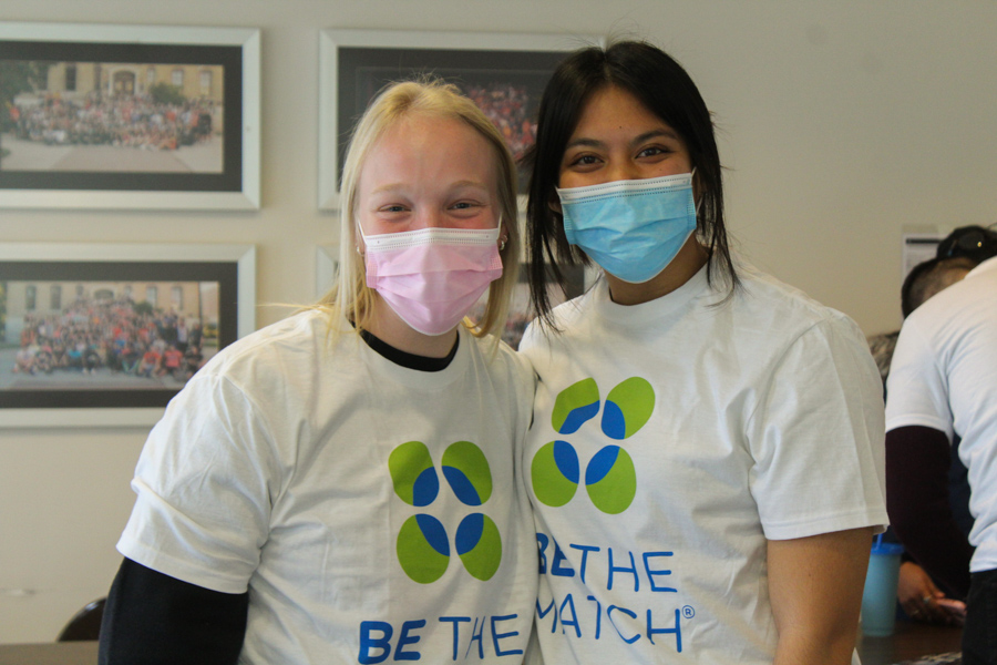 Juniors Kennedy Comstock and Anna Chieu running the Be the Match tabeling. 
