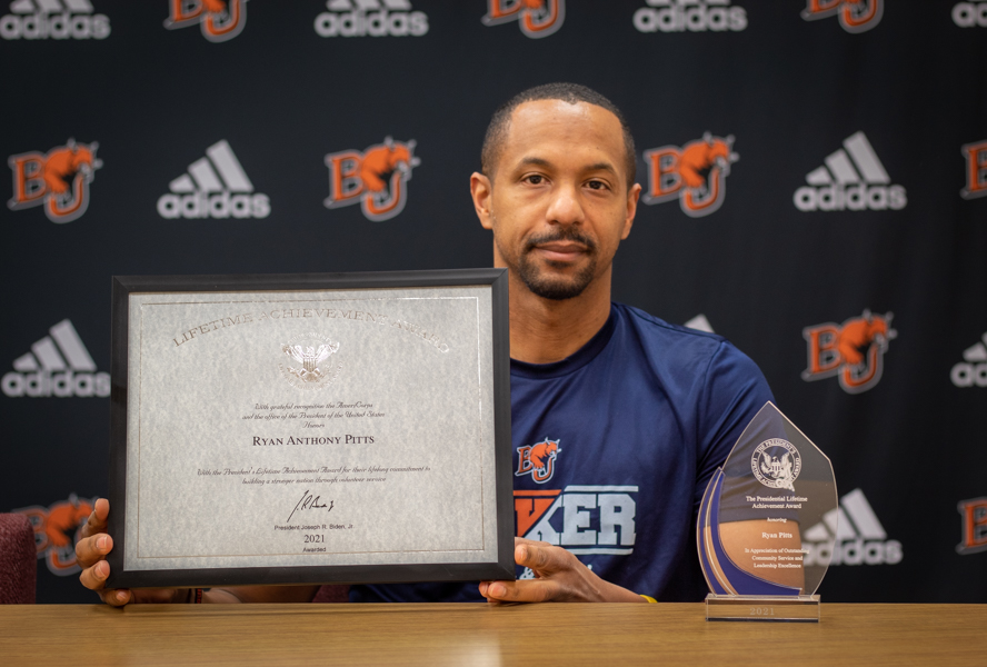 Ryan Pitts, head coach of track and field, receives the Joe Bidens Presidential Lifetime Achievement Award. Each recipient received a certificate signed by President Joe Biden.